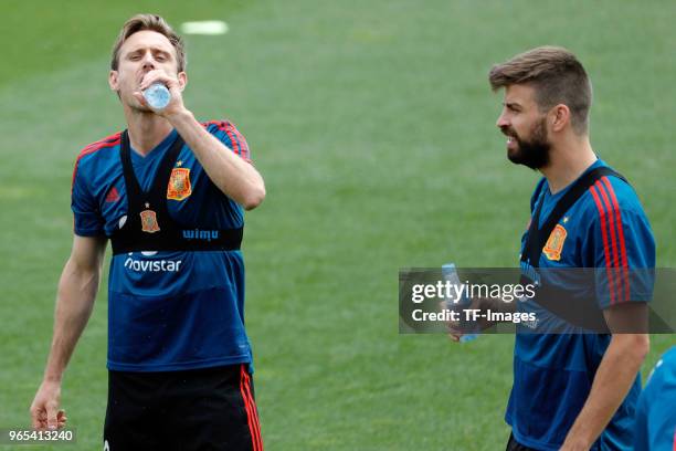 Nacho Monreal of Spain and Gerard Pique of Spain drink during a training session on May 29, 2018 in Madrid, Spain.