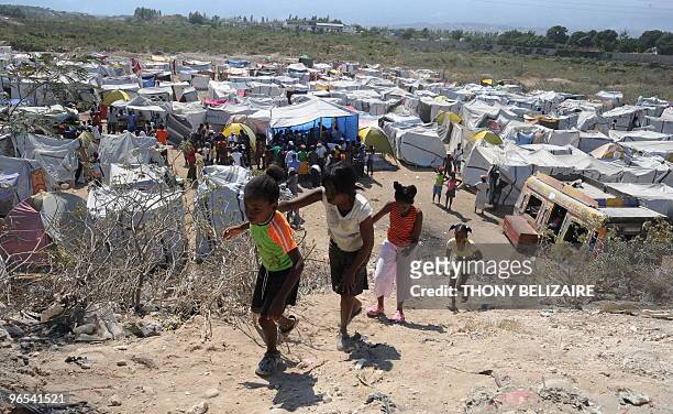 Group of people gather on February 9, 2010 at Croix des Bouquets near Port-au-Prince where the World Food Programm has set up a distribution point to...