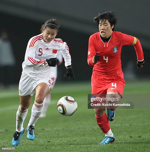 Duan Han of China and Yoo Mi Kim of South Korea compete for the ball during the East Asian Football Federation Women's Championship 2010 match...