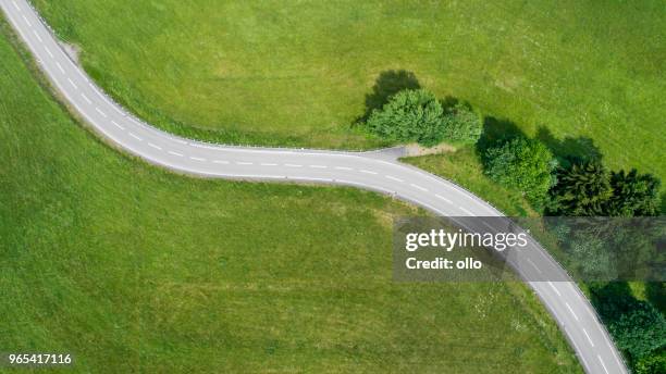 winding road and car - country road aerial stock pictures, royalty-free photos & images
