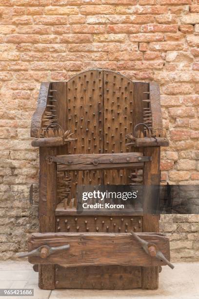 torture device - chair of torture - medieval punishment stock pictures, royalty-free photos & images
