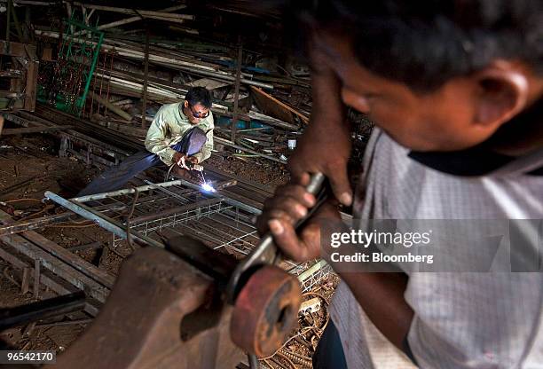 Worker welds a gate at a small metals shop in Jakarta, Indonesia, on Wednesday, Feb. 10, 2010. Indonesia's economy grew at the fastest pace in a year...