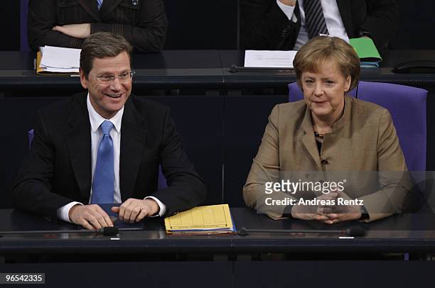 German Vice Chancellor and Foreign Minister Guido Westerwelle and German Chancellor Angela Merkel attend a session at the German Parliament at the...