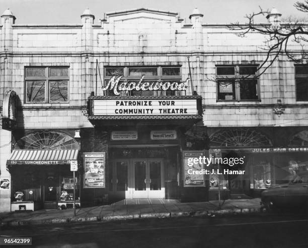 Sign outside the Maplewood Theater in Maplewood, New Jersey, reads 'Patronize your community theatre', 1953. The films showing are 'Scandal at...