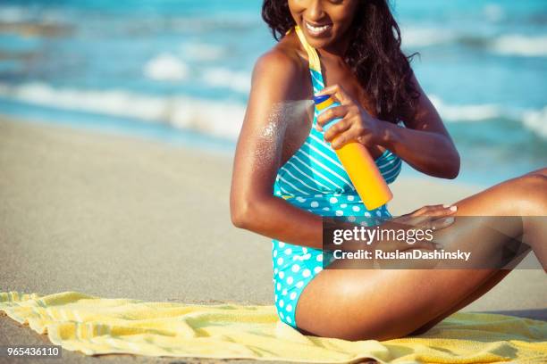 enjoy the summer but not without sun protection cream! - dark skin tone stock pictures, royalty-free photos & images