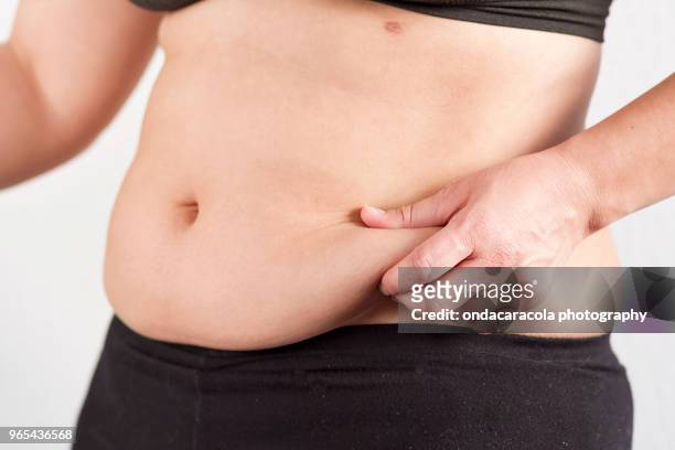 a woman's fat belly - adipose cell stock pictures, royalty-free photos & images