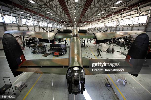 An aircraft technician works on a Lancaster Bomber at the 'Battle of Britain Memorial Flight' centre at RAF Coningsby on February 9, 2010 in...