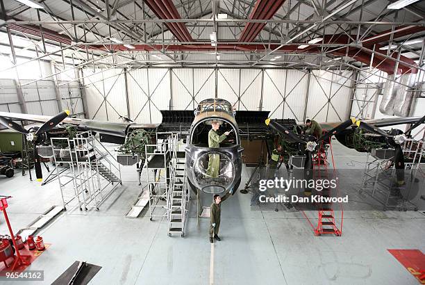 Aircraft technician Edward Cash works in the nose bay of a Lancaster Bomber at the 'Battle of Britain Memorial Flight' centre at RAF Coningsby on...