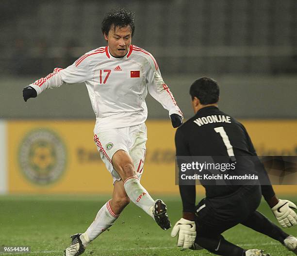 Lin Gao of China fights for the ball with Goalkeeper Woon Jae Lee of South Korea during the East Asian Football Championship 2010 match between China...