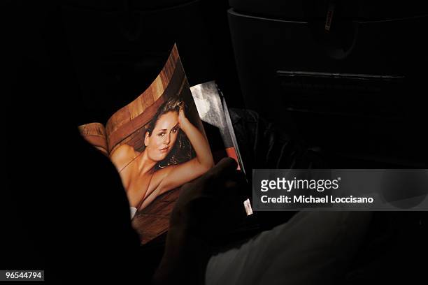 Passenger eyes a spread of skiier Lindsey Vonn while browsing the pages of the Sports Illustrated 2010 swimsuit issue on board the Sports Illustrated...