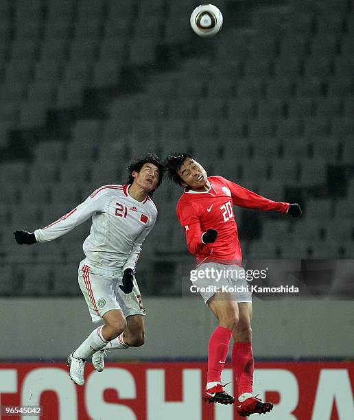 Hai Yu of China and Dong-Gook Lee of South Korea compete for the ball during the East Asian Football Championship 2010 match between China and South...