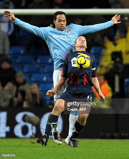 Manchester City's English defender Joleon Lescott vies with Bolton Wanderers' English forward Kevin Davies during the English Premier League football...