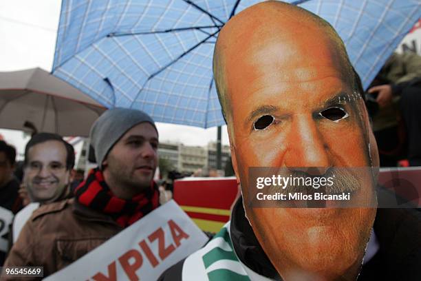Public servant wears a mask of Greek Prime Minister George Papandreou while demonstrating during the 24-hours strike held by public sector workers on...