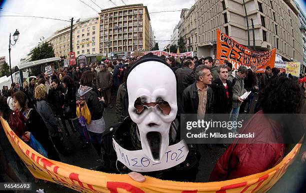 Public servant wears a skull mask and holds a placard reading: "employed" while demonstrating during a 24-hours strike held by public sector workers...