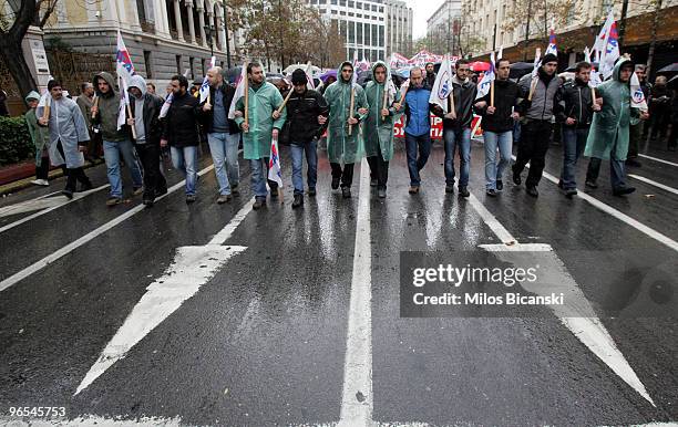 Public servants march along a city centre street during a 24-hours strike held by public sector workers on February 10, 2010 in Athens, Greece....