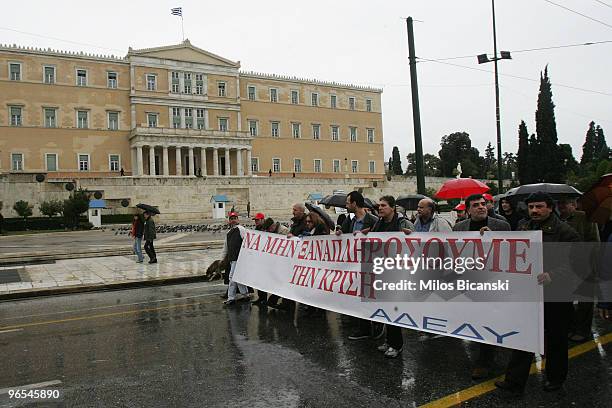 Crowd of public sector workers march with banners and placards outside Parliament during a 24-hour strike held by public sector workers on February...