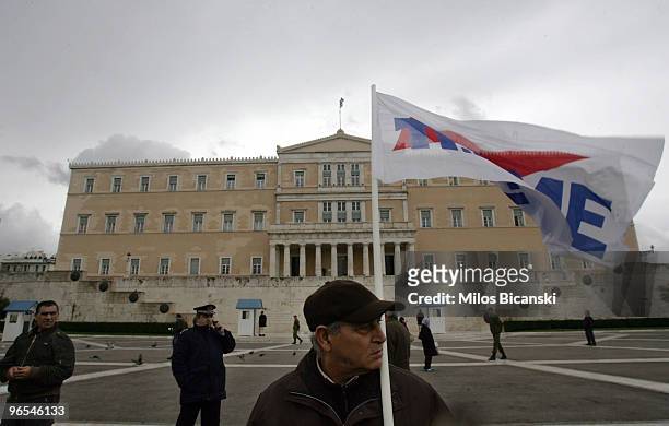 Man holds a banner outside Parliament during a 24-hours strike held by public sector workers on February 10, 2010 in Athens, Greece. Government...