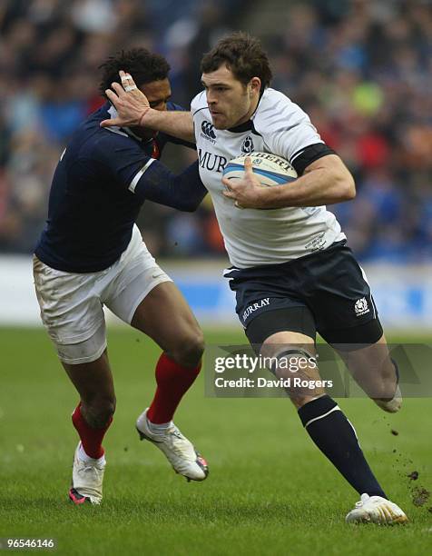 Sean Lamont of Scotland holds off a tackle during the RBS Six Nations Championship match between Scotland and France at Murrayfield Stadium on...