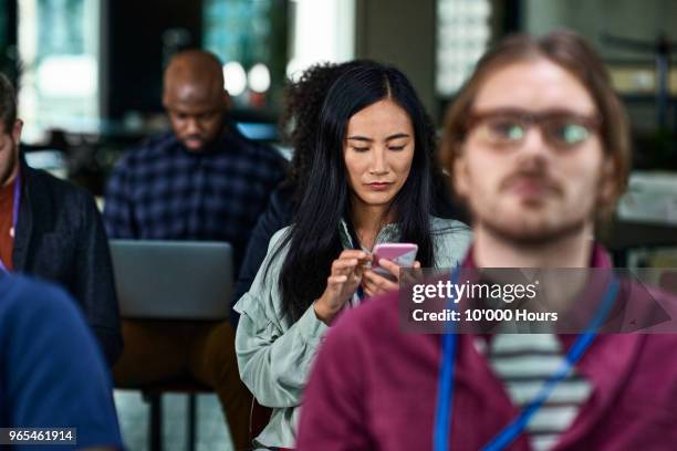 audience at conference - meeting checking phone stock pictures, royalty-free photos & images