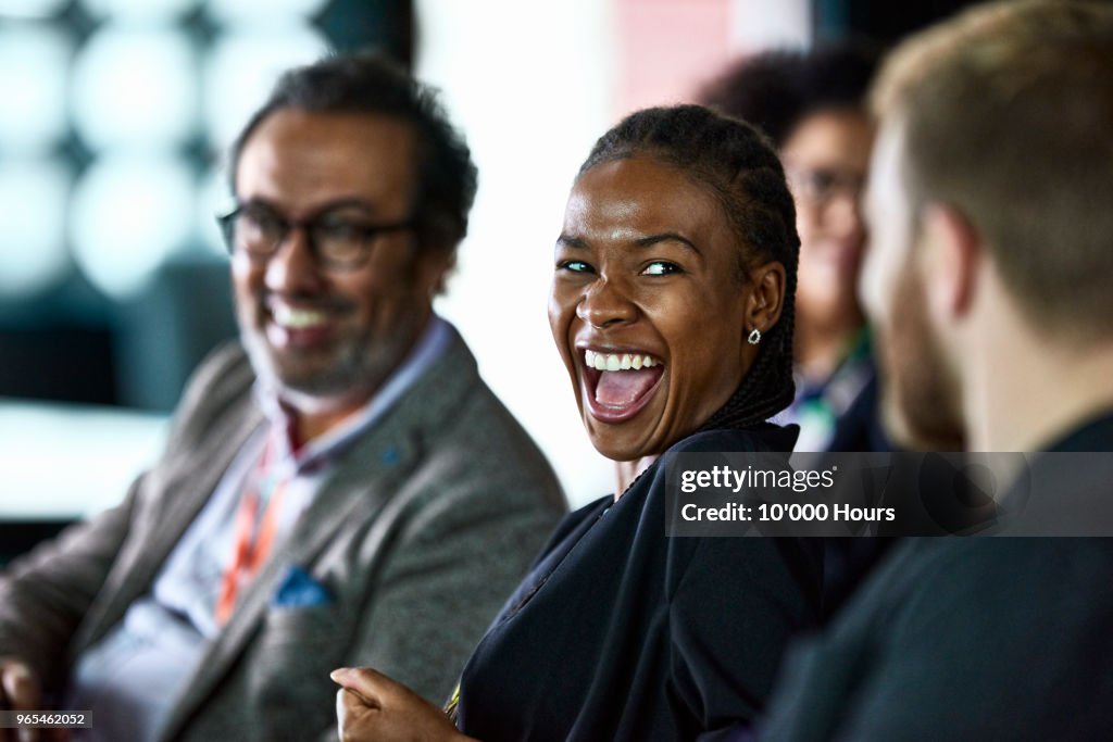 Businesspeople laughing at conference