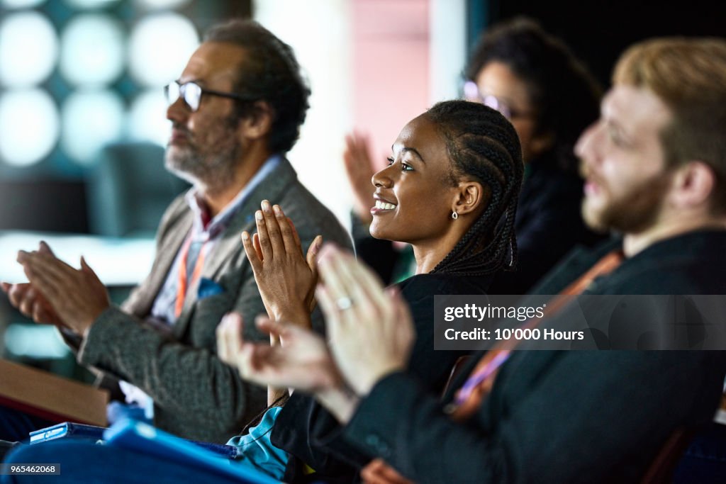 Audience applauding at conference