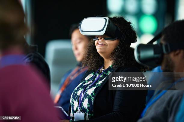 woman with vr glasses at conference - tech conference event stock pictures, royalty-free photos & images