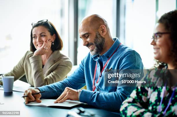 people having meeting in office - 3 people at table talking stock pictures, royalty-free photos & images