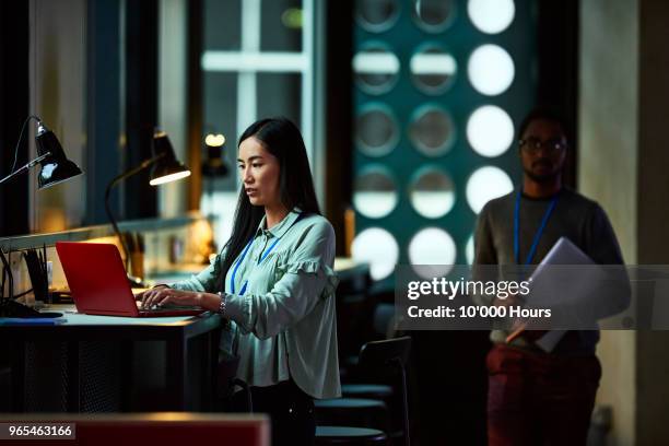 woman using laptop in office - busy woman stock-fotos und bilder