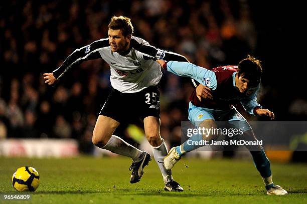 David Elm of Fulham battles for the ball with Jack Cork of Burnley during the Barclays Premier League match between Fulham and Burnley at Craven...