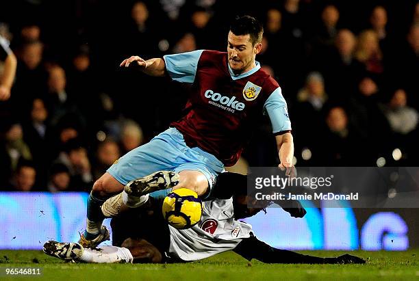 Dickson Etuhu of Fulham tackles David Nugent of Burnley during the Barclays Premier League match between Fulham and Burnley at Craven Cottage on...