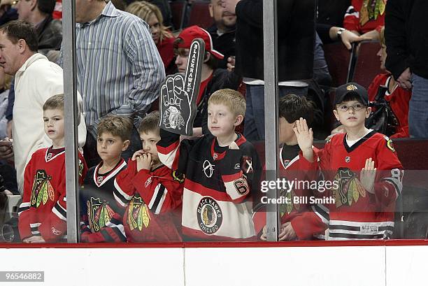 Six young male fans of the Chicago Blackhawks watch warmups before the game against the Phoenix Coyotes on February 05, 2010 at the United Center in...