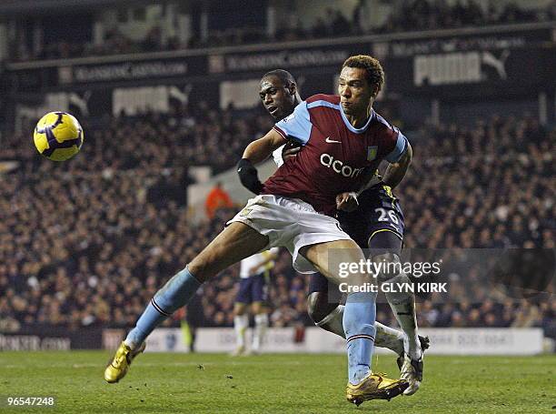 Tottenham Hotspur's English defender Ledley King vies with Aston Villa's Norwegian striker John Carew during the English Premier League football...