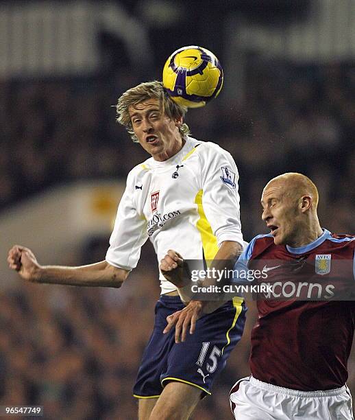 Tottenham Hotspur's English striker Peter Crouch vies with Aston Villa's Welsh defender James Collins during the English Premier League football...