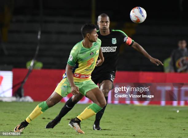 Jorge Ramos of Huila fights for the ball with Alexis Henriquez of Nacional during semifinal first leg match between Atletico Huila and Atletico...
