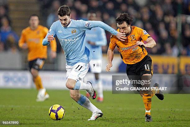 Hull City's Irish midfielder Stephen Hunt vies with Manchester City's English midfielder Adam Johnson during the English Premier League football...