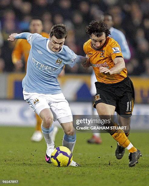 Hull City's Irish midfielder Stephen Hunt vies with Manchester City's English midfielder Adam Johnson during the English Premier League football...