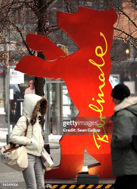 People bundled in winter clothing walk past a Berlinale Bear statue in subzero temperatures ahead of the 60th Berlinale International Film Festival...