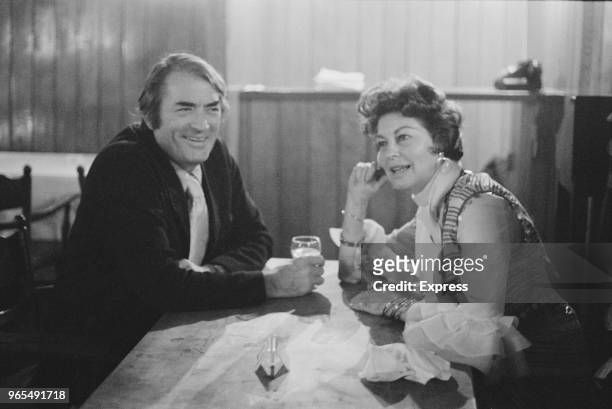American actors Gregory Peck and Ava Gardner share a glass of wine at a cafe in Earls Court, London on 3rd July 1973.