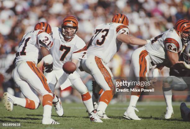 Boomer Esiason, Quarterback for the Cincinnati Bengals hands off the ball to Running Back James Brooks during the American Football Conference...