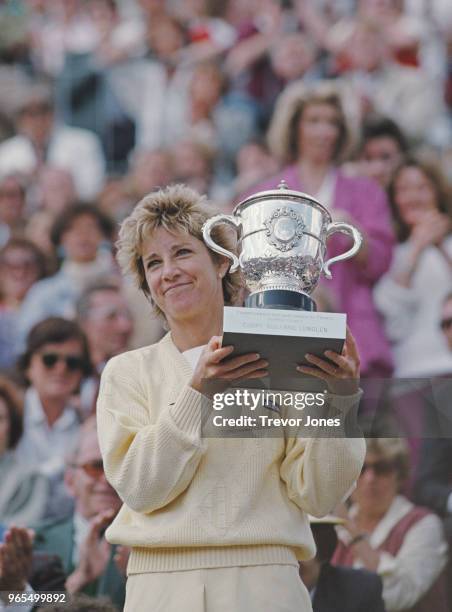 Chris Evert of the United States holds the Suzanne-Lenglen Cup after her victory over defending champion Martina Navratilova during their Women's...