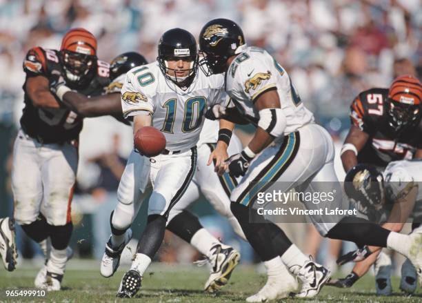 Jamie Martin, Quarterback for the Jacksonville Jaguars hands the ball off to Running Back Fred Taylor during the American Football Conference Central...