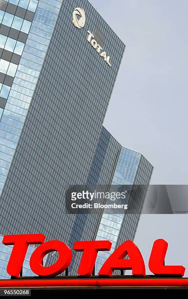The headquarters of Total SA stand behind a gas station on the Esplanade de la Defense in Paris, France, on Wednesday, Feb. 10, 2010. The company...