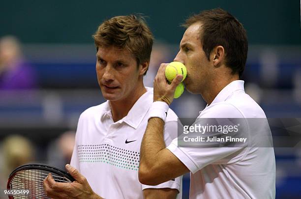 Simon Aspelin of Sweden and Paul Hanley of Australia talk tactics during their first round doubles match against Simone Bolelli and Andreas Seppi of...