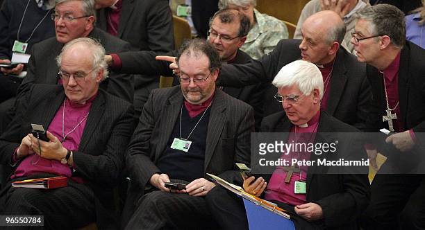 The Bishop of Chester Peter Forster , The Bishop of Liverpool James Jones and The Bishop of Southwark Tom Butler try to vote using an electronic key...