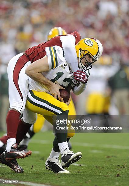 Bertrand Berry of the Arizona Cardinals sacks Aaron Rodgers of the Green Bay Packers in the NFC wild-card playoff game at University of Phoenix...