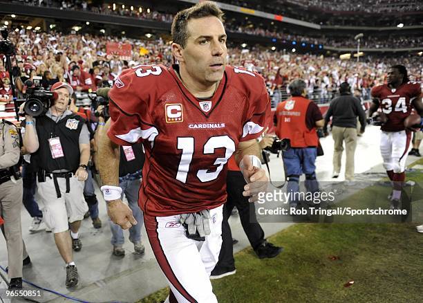 Kurt Warner of the Arizona Cardinals walks onto the field after defeating the Green Bay Packers in the NFC wild-card playoff game at University of...