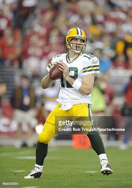 Aaron Rodgers of the Green Bay Packers looks to pass against the Arizona Cardinals in the NFC wild-card playoff game at University of Phoenix Stadium...