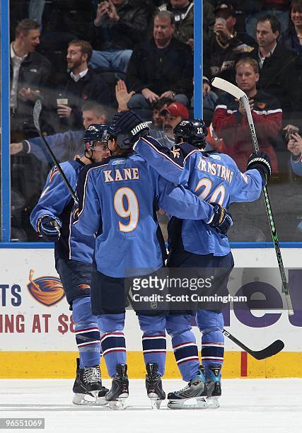Colby Armstrong of the Atlanta Thrashers is congratulated by Evander Kane and Rich Peverley after scoring against the Anaheim Ducks at Philips Arena...