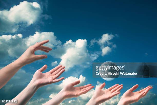 hands seem to reach  the another earth - composite bonding stock pictures, royalty-free photos & images