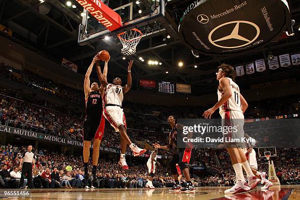 Jawad Williams of the Cleveland Cavaliers rebounds the ball against Rasho Nesterovic of the Toronto Raptors during the game on January 19, 2010 at...